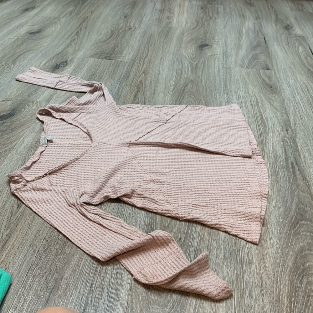 A cute light pink sweater.